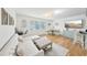 Bright living room with sectional sofa, wood floors, and dining area at 210 5Th S Ave # 307, St Petersburg, FL 33701