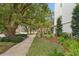 Attractive street view with mature trees and well-maintained landscaping at 210 5Th S Ave # 307, St Petersburg, FL 33701
