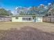 House exterior view from backyard, showing a wooden fence at 2148 Cunningham Dr, Clearwater, FL 33763