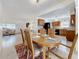 Bright dining room with kitchen access and wood table at 2148 Cunningham Dr, Clearwater, FL 33763