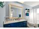 Bright bathroom with a white tub and blue vanity at 2215 1St St # A & B, Indian Rocks Beach, FL 33785