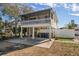 Elevated beach cottage with a porch and fenced yard at 2215 1St St # A & B, Indian Rocks Beach, FL 33785