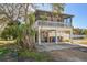 Elevated beach cottage with a porch and fenced yard at 2215 1St St # A & B, Indian Rocks Beach, FL 33785