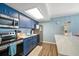 Updated kitchen with stainless steel appliances and blue cabinetry at 2215 1St St # A & B, Indian Rocks Beach, FL 33785