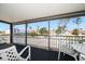 Spacious screened porch with outdoor furniture and street view at 2215 1St St # A & B, Indian Rocks Beach, FL 33785