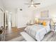 Bright bedroom with a queen-size bed and wood-look floors at 2794 Countryside Blvd # 1, Clearwater, FL 33761