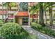Condo building entrance with landscaping and walkway at 3062 Eastland Blvd # 405, Clearwater, FL 33761