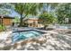 Community hot tub with nearby pool and lounge chairs at 3062 Eastland Blvd # 405, Clearwater, FL 33761