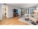Living room with hardwood floors, comfy seating, and access to a balcony at 3062 Eastland Blvd # 405, Clearwater, FL 33761