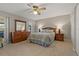 Bright bedroom with a wooden dresser, ceiling fan and plenty of closet space at 3305 Gorse Ct, Palm Harbor, FL 34684