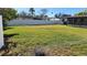 Large grassy backyard with a white vinyl fence at 4119 Harrisburg Ne St, St Petersburg, FL 33703