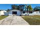 White single story house with a palm tree and driveway at 4119 Harrisburg Ne St, St Petersburg, FL 33703
