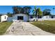 White single story house with a palm tree and driveway at 4119 Harrisburg Ne St, St Petersburg, FL 33703