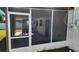 Screened patio with table and access to the backyard at 4119 Harrisburg Ne St, St Petersburg, FL 33703