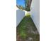 Side yard with grass and a white fence at 4119 Harrisburg Ne St, St Petersburg, FL 33703