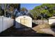 White shed with double doors in the backyard at 4427 Gandy Cir, Tampa, FL 33616