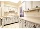 View of a kitchen with white cabinets and a pass through to another room at 4427 Gandy Cir, Tampa, FL 33616