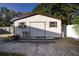Small off-white shed with a window and steps at 4427 Gandy Cir, Tampa, FL 33616