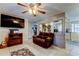 Cozy living room featuring a brown leather couch and a large TV at 4631 Pirate Pl, New Port Richey, FL 34652