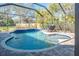 Inviting pool area with covered patio and lounge chairs at 512 Creekside Ct, Safety Harbor, FL 34695