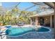 Inviting screened pool with paved patio and lounge chair at 512 Creekside Ct, Safety Harbor, FL 34695