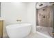 Modern bathroom with a large walk-in shower and a freestanding bathtub at 519 Loquat Dr, Anna Maria, FL 34216