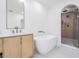 Spa-like bathroom featuring a soaking tub and a walk-in shower at 519 Loquat Dr, Anna Maria, FL 34216