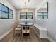 Bright dining room with an oval table and built-in bench seating at 519 Loquat Dr, Anna Maria, FL 34216
