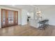 Light and airy entryway with wood door and built-in bench at 519 Loquat Dr, Anna Maria, FL 34216