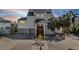 Two-story home with white exterior, metal roof, and landscaped yard at 519 Loquat Dr, Anna Maria, FL 34216
