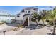 Two story home with white exterior, metal roof, and landscaped yard at 519 Loquat Dr, Anna Maria, FL 34216