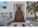 Front view of home with stairs and landscaping at 519 Loquat Dr, Anna Maria, FL 34216