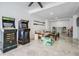 Basement game room with arcade games, seating area, and marble flooring at 519 Loquat Dr, Anna Maria, FL 34216