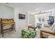 Bright game room with seating area, large TV, and access to a pool at 519 Loquat Dr, Anna Maria, FL 34216
