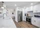 Modern kitchen with stainless steel appliances and white shaker cabinets at 519 Loquat Dr, Anna Maria, FL 34216