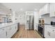 Modern kitchen with stainless steel appliances and white shaker cabinets at 519 Loquat Dr, Anna Maria, FL 34216