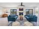 Spacious living room with fireplace and access to balcony at 519 Loquat Dr, Anna Maria, FL 34216