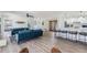 Open living area with blue sofas and a view of the kitchen at 519 Loquat Dr, Anna Maria, FL 34216