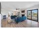 Open living room with fireplace, two blue sofas, and water views at 519 Loquat Dr, Anna Maria, FL 34216