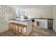 Modern outdoor kitchen with barstools and grill at 519 Loquat Dr, Anna Maria, FL 34216