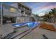 Lighted pool and spa with lounge chairs at 519 Loquat Dr, Anna Maria, FL 34216