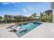 Relaxing pool and spa area with waterfront views and lounge chairs at 519 Loquat Dr, Anna Maria, FL 34216