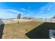 Spacious backyard with pond view and white fence at 5462 Logan Cave Ave, Wimauma, FL 33598