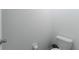 Small powder room with toilet and simple decor at 5462 Logan Cave Ave, Wimauma, FL 33598