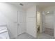 Main bathroom with double vanity and access to a toilet and walk-in closet at 5462 Logan Cave Ave, Wimauma, FL 33598