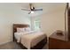 Spacious bedroom with a large bed and window with blinds at 5462 Logan Cave Ave, Wimauma, FL 33598