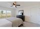 Bright bedroom with large window, ceiling fan, and dresser at 5462 Logan Cave Ave, Wimauma, FL 33598