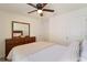 Well-lit bedroom with a dresser and a comfortable bed at 5462 Logan Cave Ave, Wimauma, FL 33598