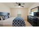 Bedroom with full bed, ceiling fan and dresser at 5462 Logan Cave Ave, Wimauma, FL 33598