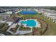 Community pool with lounge chairs and a pool house at 5462 Logan Cave Ave, Wimauma, FL 33598